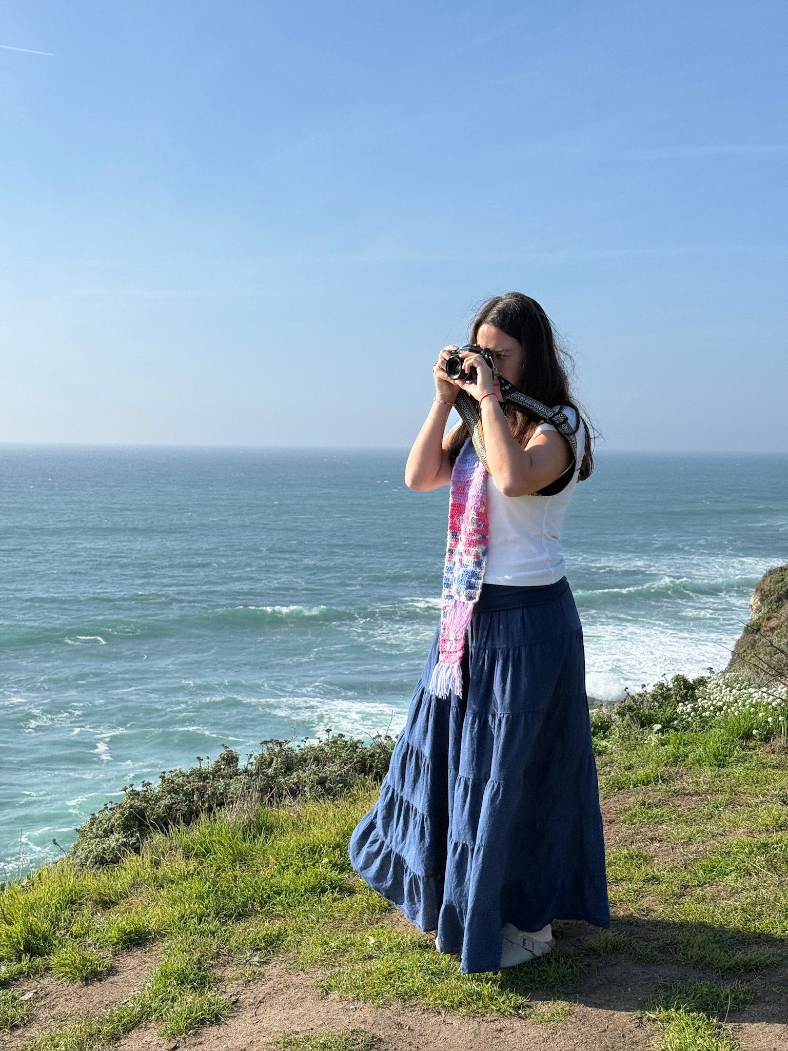 The filmmaker shooting on a cliff above the ocean